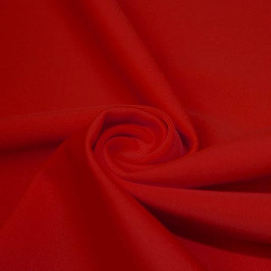 A swirled piece of matte nylon spandex fabric in the color red.