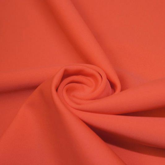A swirled piece of matte nylon spandex fabric in the color rose.