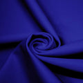 A swirled piece of matte nylon spandex fabric in the color royal.