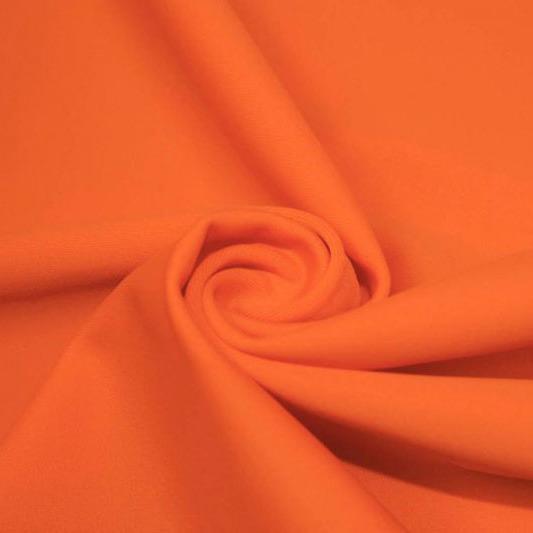 A swirled piece of matte nylon spandex fabric in the color rust.