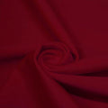 A swirled piece of matte nylon spandex fabric in the color scarlet.