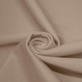 A swirled piece of matte nylon spandex fabric in the color taupe.