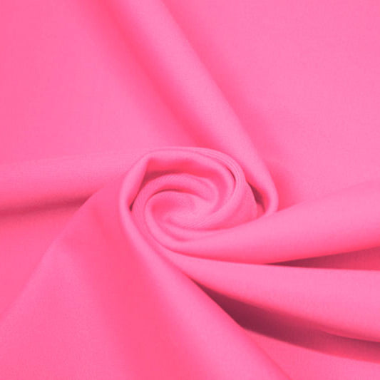 A swirled piece of matte nylon spandex fabric in the color tropic pink.