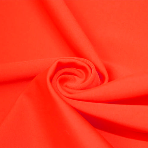 A swirled piece of matte nylon spandex fabric in the color vivid glow.