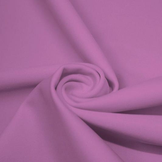 A swirled piece of matte nylon spandex fabric in the color wild orchid.