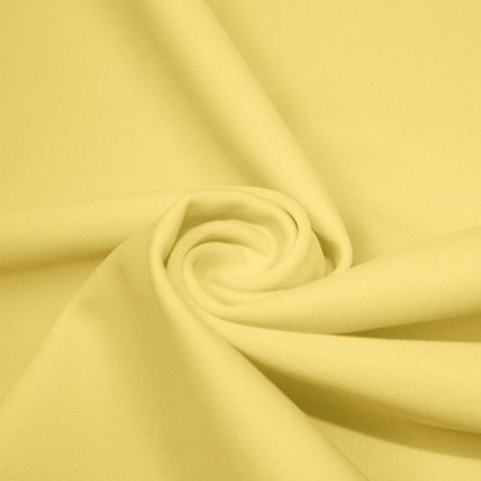 A swirled piece of matte nylon spandex fabric in the color yellow.