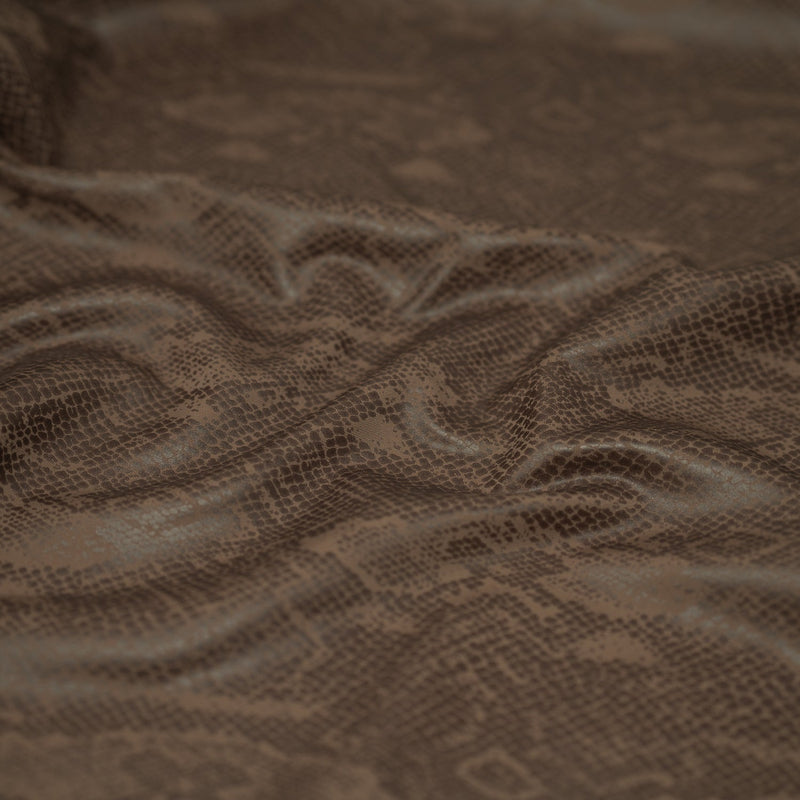 Detailed shot of Medusa Snake Skin Foil Printed Spandex in the color Brown