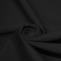 A swirled piece of microfiber nylon spandex in the color black.