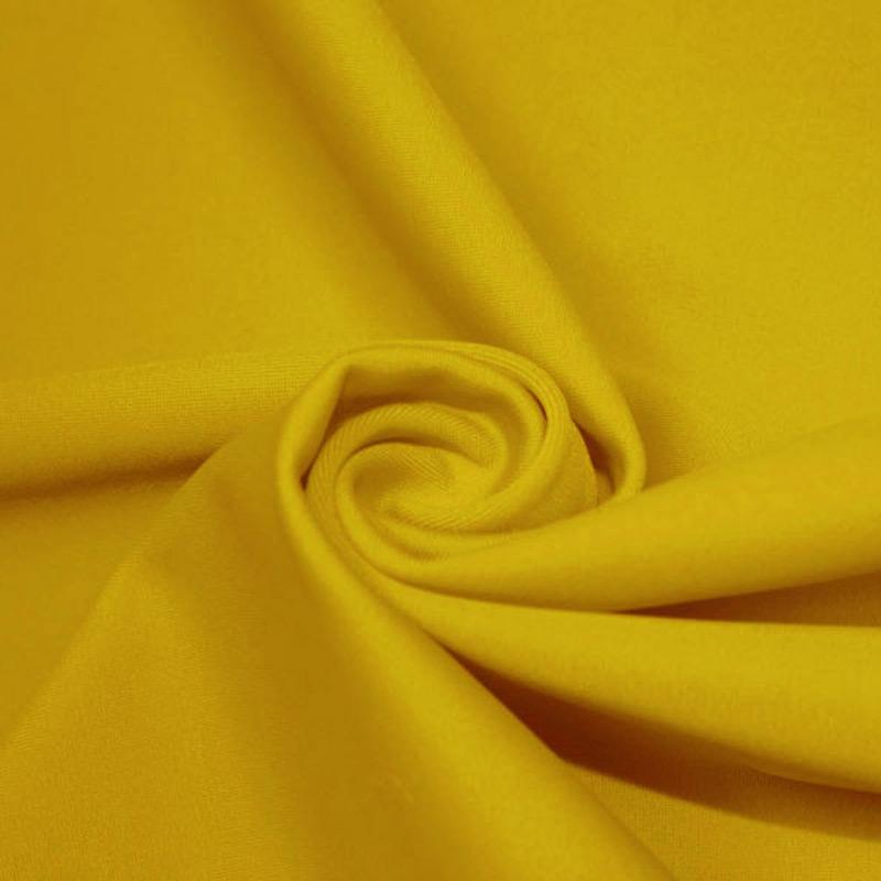 A swirled piece of microfiber nylon spandex in the color halei yellow.