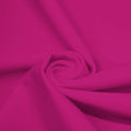 A swirled piece of microfiber nylon spandex in the color mixed pink.