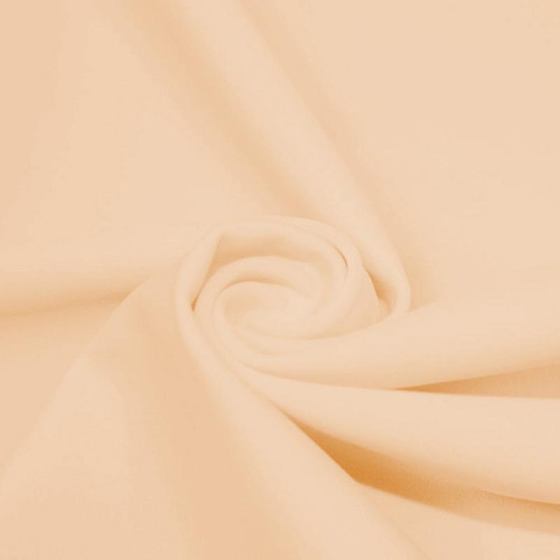 A swirled piece of microfiber nylon spandex in the color naked.