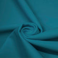 A swirled piece of microfiber nylon spandex in the color new jade.