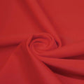 A swirled piece of microfiber nylon spandex in the color red.