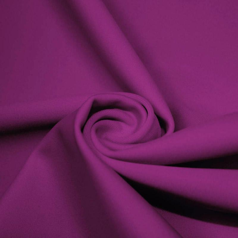 A swirled piece of microfiber nylon spandex in the color rosebud.