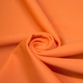A swirled piece of microfiber nylon spandex in the color rust.