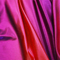 A sample of ombre mystique foiled spandex in the color orange-purple.