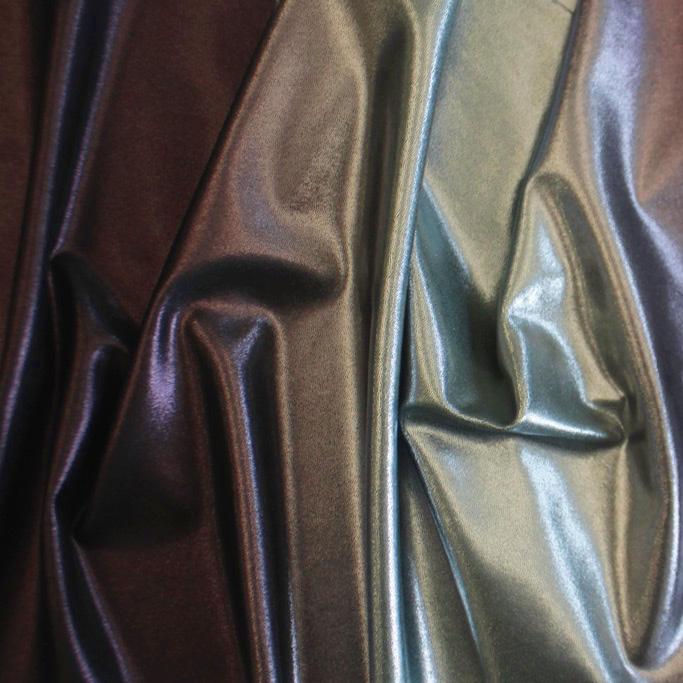 A sample of ombre mystique foiled spandex in the color silver-black.
