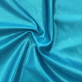 A swirled piece of Mystique Pearl foiled spandex with blue foil on an ocean base.