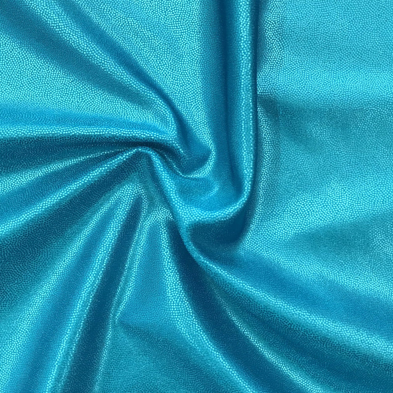 A swirled piece of Mystique Pearl foiled spandex with blue foil on an ocean base.