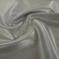 A swirled piece of Mystique Pearl foiled spandex with silver foil on a platinum base.