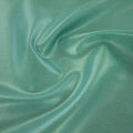 A swirled piece of Mystique Pearl foiled spandex with mint foil on a spring green base.