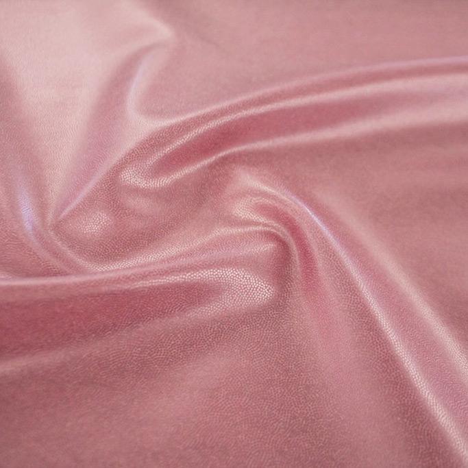 A swirled piece of Mystique Pearl foiled spandex with baby pink foil on a taffy base.