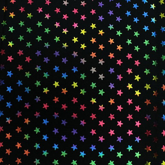 A flat sample of Rainbow Stars on Black Foiled Spandex.