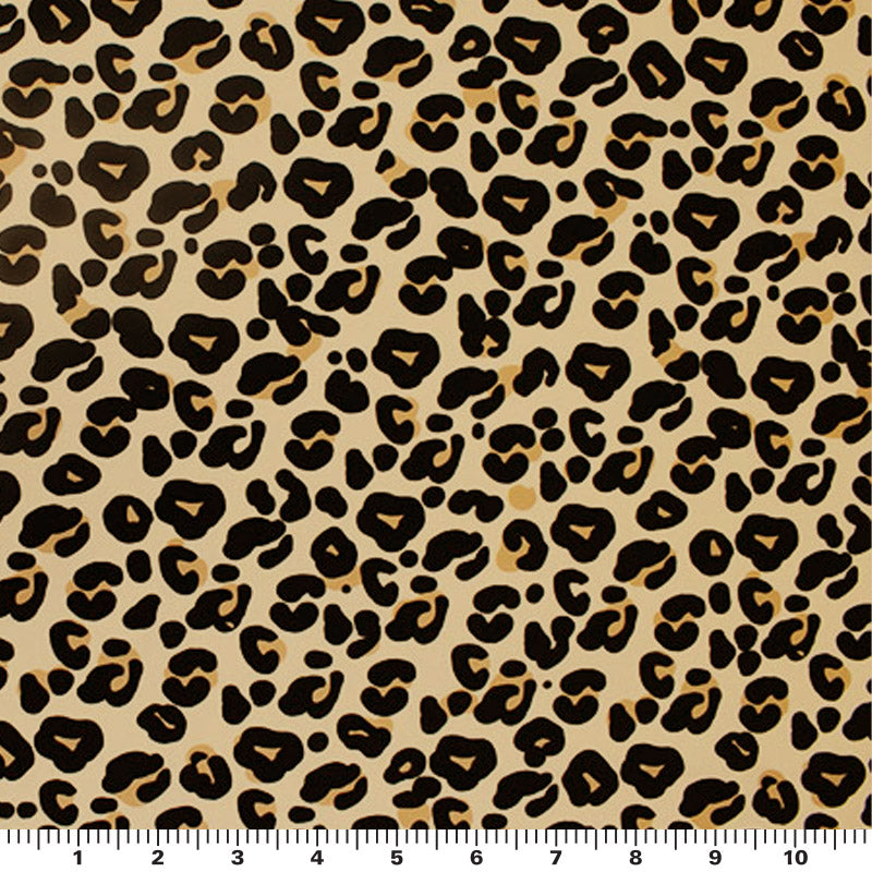 A sample of Cream Leopard Printed Spandex and a ruler for scale. Design includes leopard prints in a neutral background.