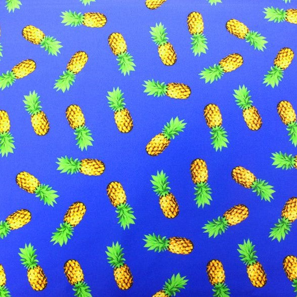 A flat sample of pineapples printed spandex.