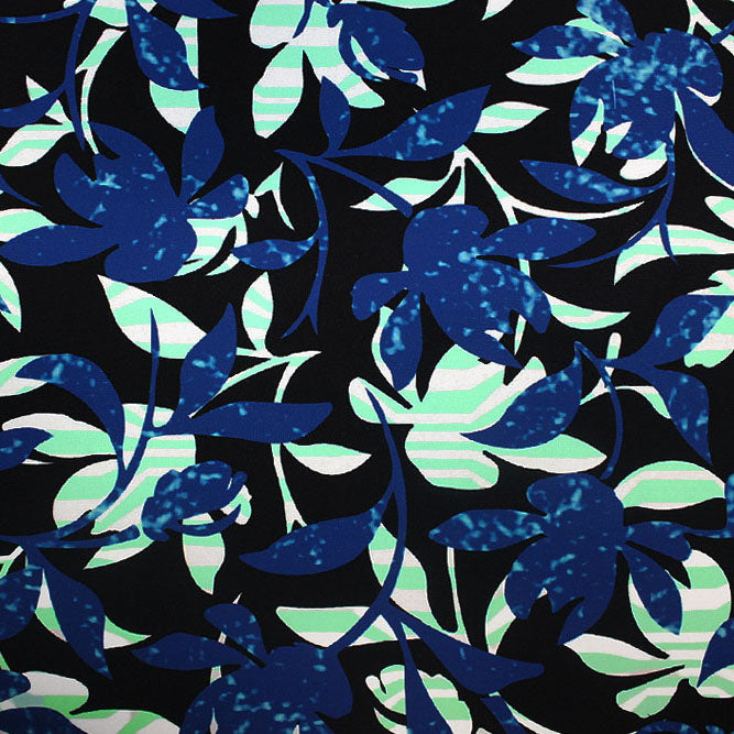 A flat sample of evening leaves and branches printed spandex.