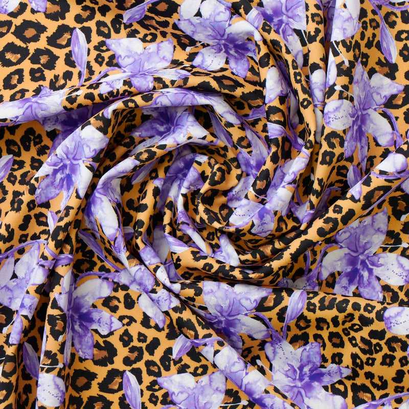 Swirled piece of Leopard and Purple Flowers Printed Spandex.