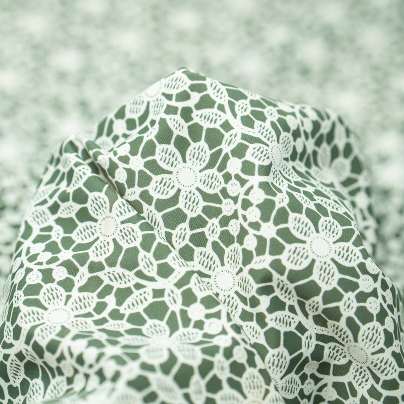 Detailed photograph of White Flower Lace Pattern on Sage Printed Spandex