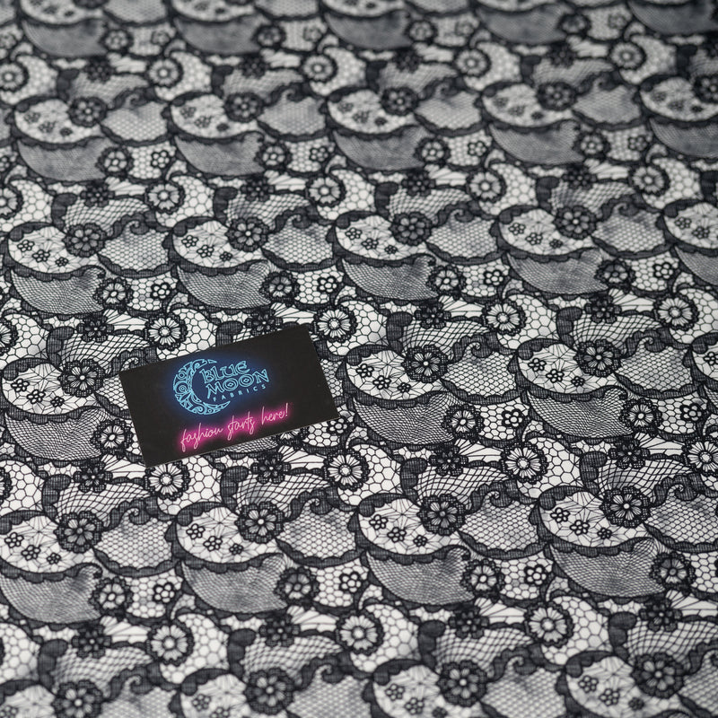 A flat sample of Black Paisley Lace Pattern on White Printed Spandex