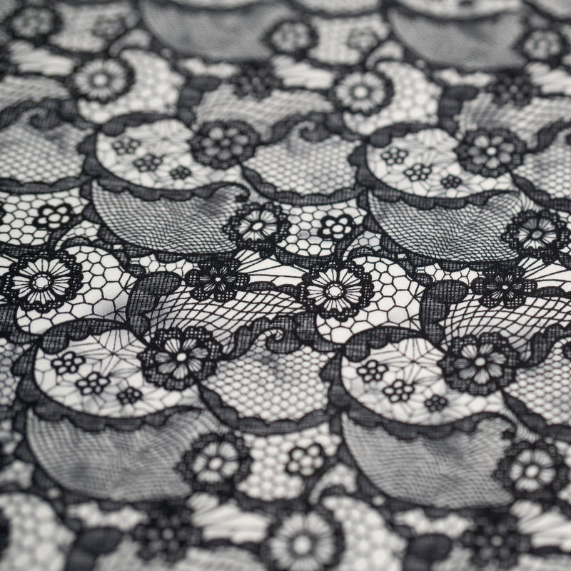 A flat sample of Black Paisley Lace Pattern on White Printed Spandex