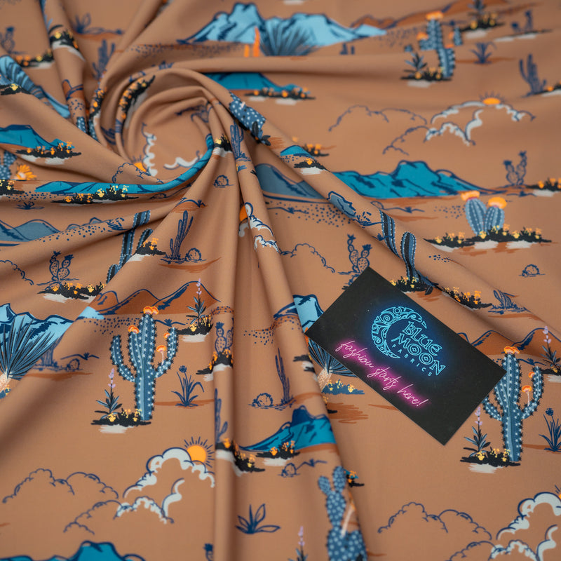 Swirled sample shot of Western Desert Bloom Printed Spandex with a Blue Moon Fabrics standard size business card laid on top of the print for pattern sizing.