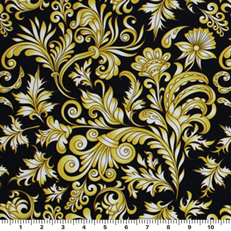 A flat sample of gold black baroque printed  spandex with a scale to measure the size of the design.