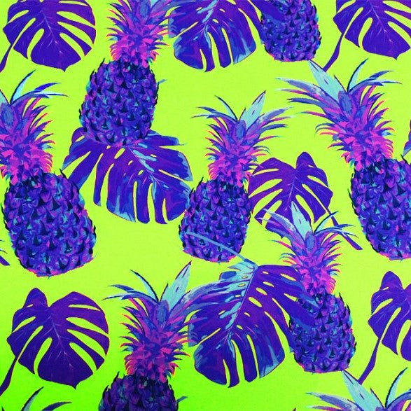 A flat sample of purple pineapples printed spandex.