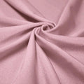 A swirled piece of shiny nylon spandex in the color blush.