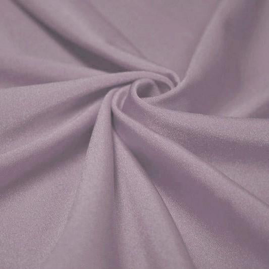 A swirled piece of shiny nylon spandex in the color plush.