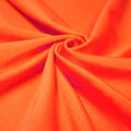 A swirled piece of shiny nylon spandex in the color vivid glow.