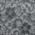 A flat sample of nadia scalloped stretch lace in the color pewter gray.