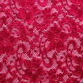 A flat sample of nadia scalloped stretch lace in the color wine red.