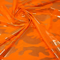 Detailed shot of Neon Nugi Foil Printed Cationic Spandex in color Tangerine Gold.