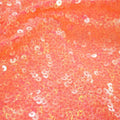 A flat sample of dayglo spandex sequin in the color neon orange.