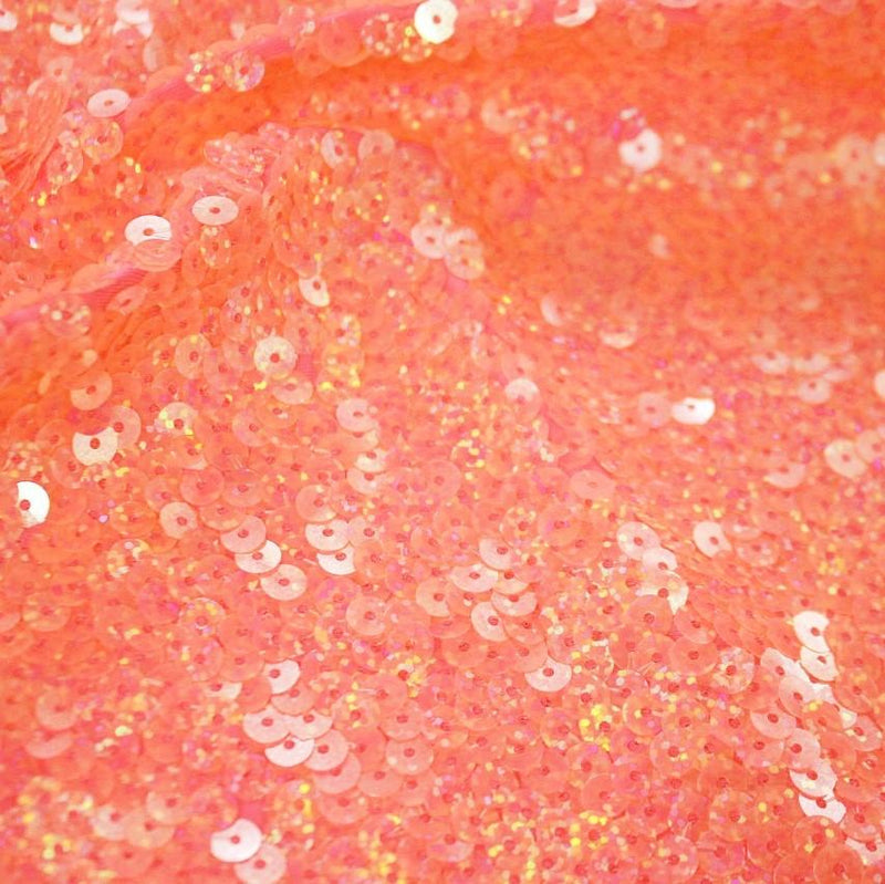 A flat sample of dayglo spandex sequin in the color neon orange.
