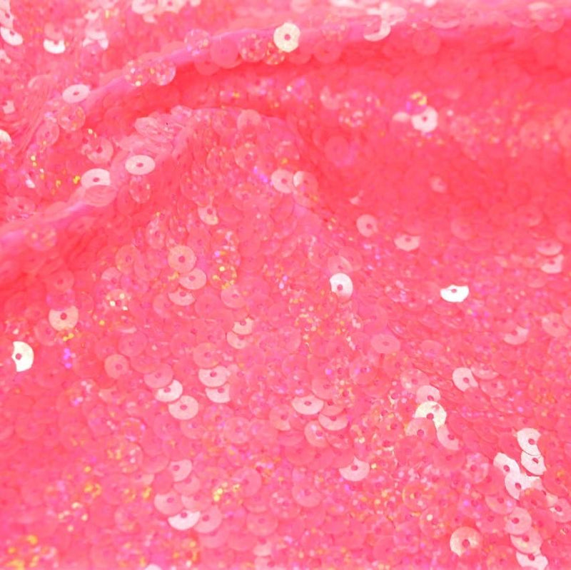 A flat sample of dayglo spandex sequin in the color neon pink.