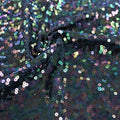 A swirled sample of night sky sequin spandex in the color deep sea iridescent.
