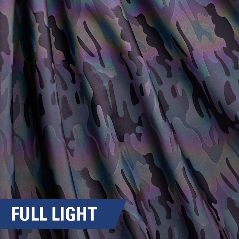 A rippled piece of Nocturnal Rainbow Reflective Spandex with a camouflage print under full light.