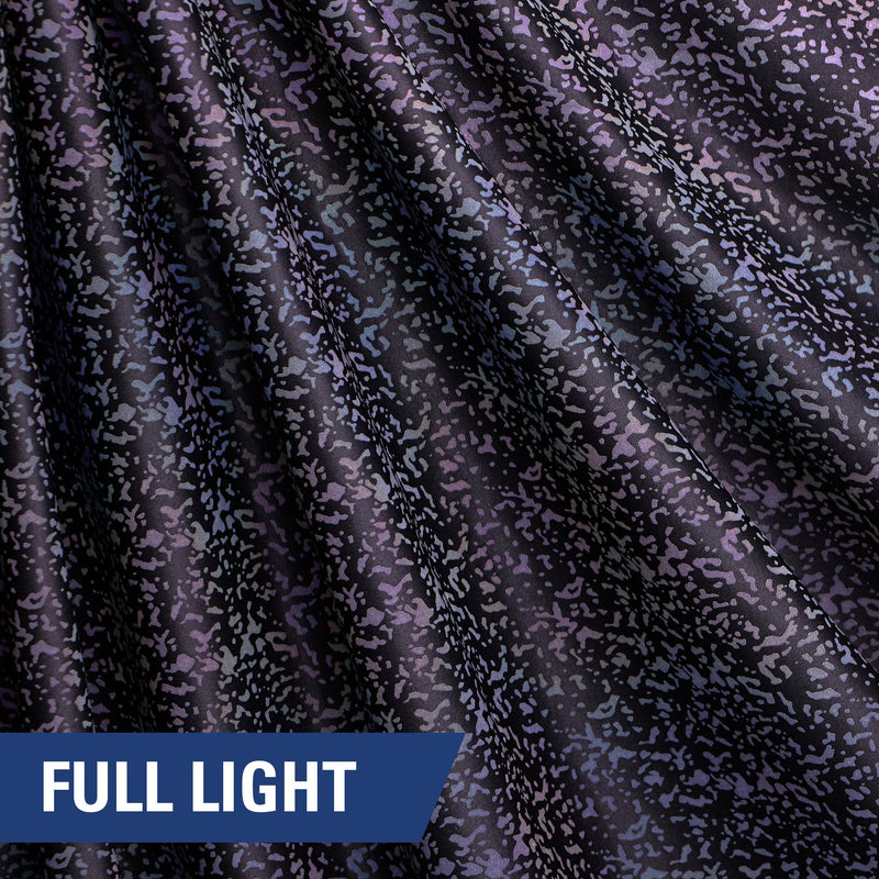 A rippled piece of Nocturnal Rainbow Reflective Spandex with a splatter print under full light.