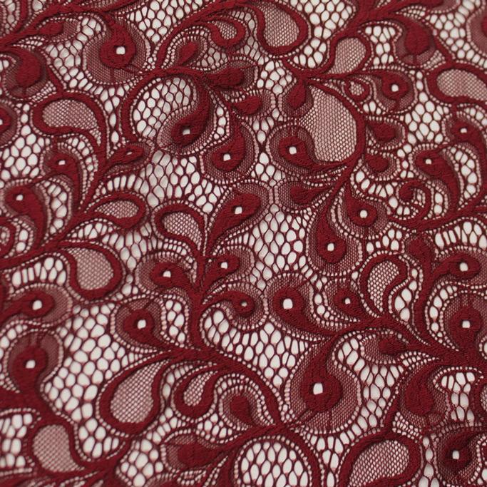 A falt sample of olivia stretch lace in the color merlot red.